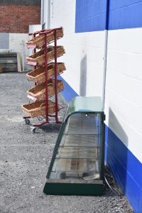 a long metal conveyor belt in front of a building
