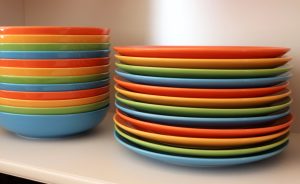 a stack of colorful plates sitting on top of a counter